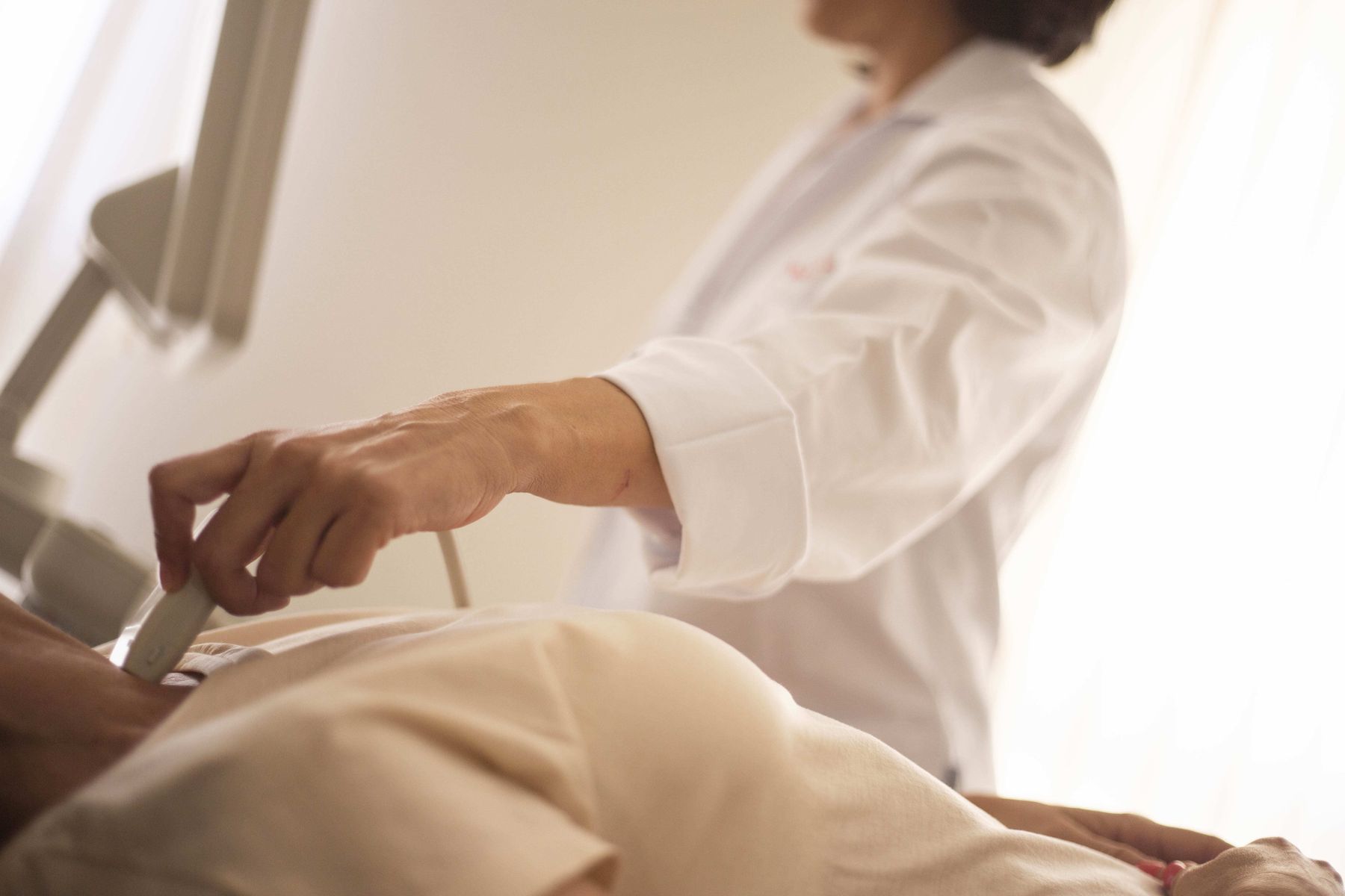 A sonographer performing a diagnostic ultrasound at the bedside