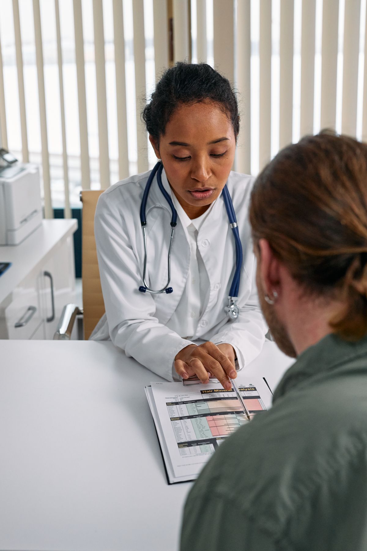 A clinician and patient in a private practice exam room